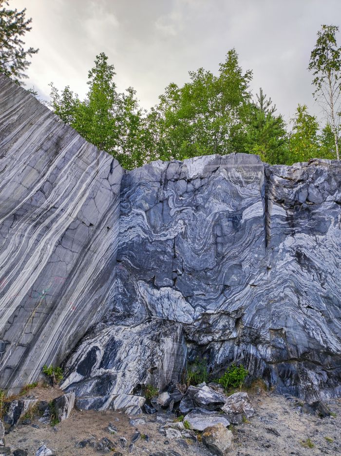 Crafting Captivating Headlines: Your awesome post title goes here Dramatic marble rock formation in a lush forest setting, showcasing stunning natural patterns.